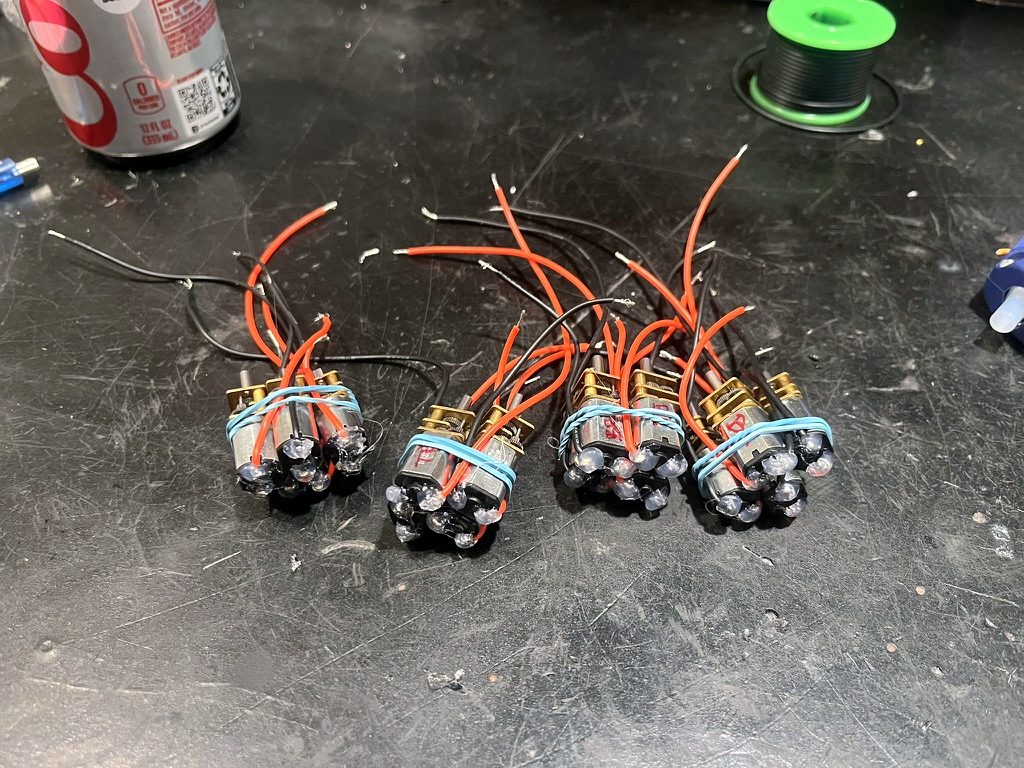 Four bundles of gear motors with hot-glued solder joints
