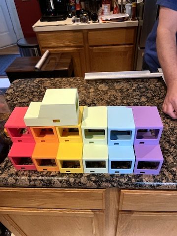 Stacks of 3D-printed car tops in rainbow colors